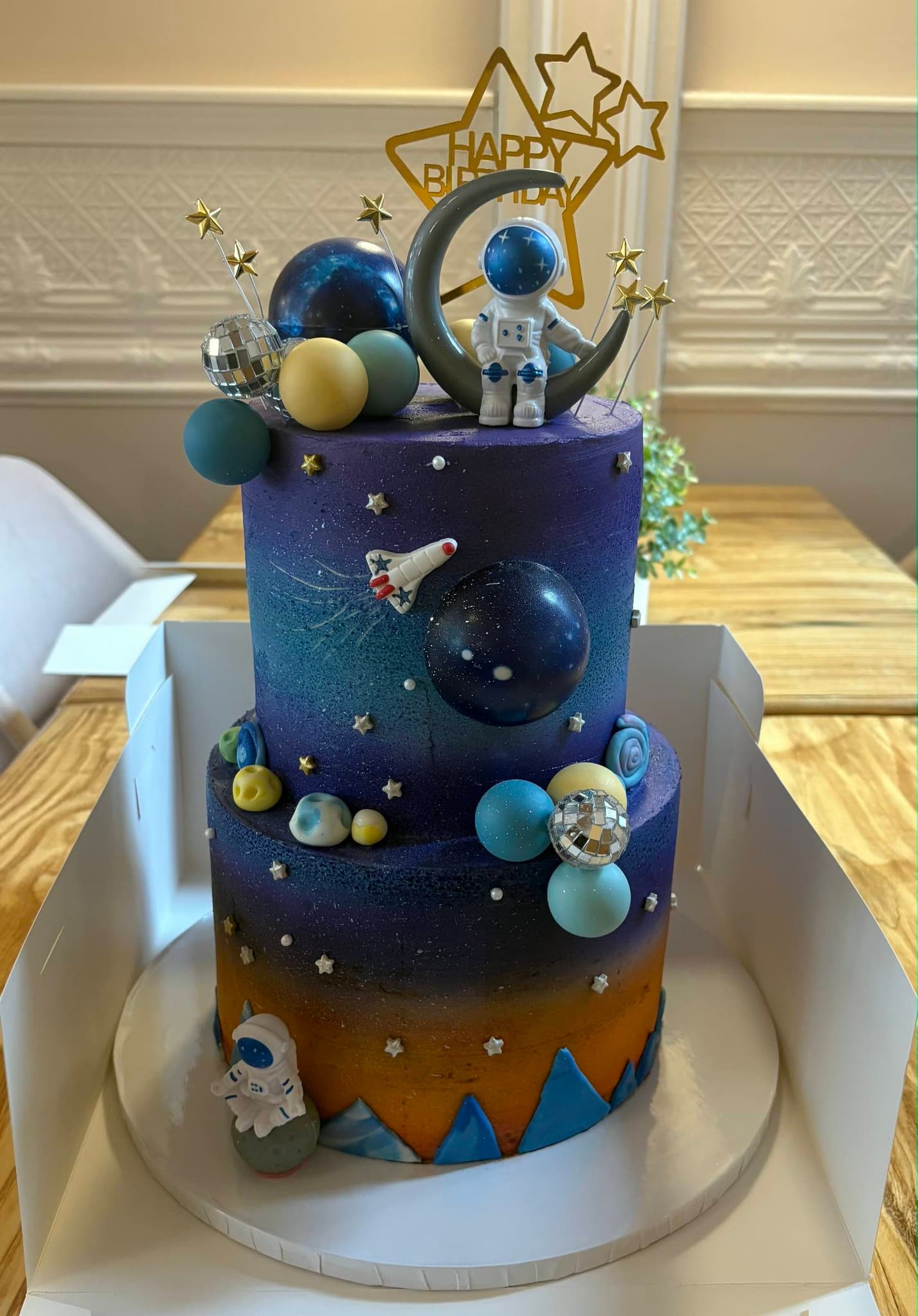 Multitiered birthday cake with space theme